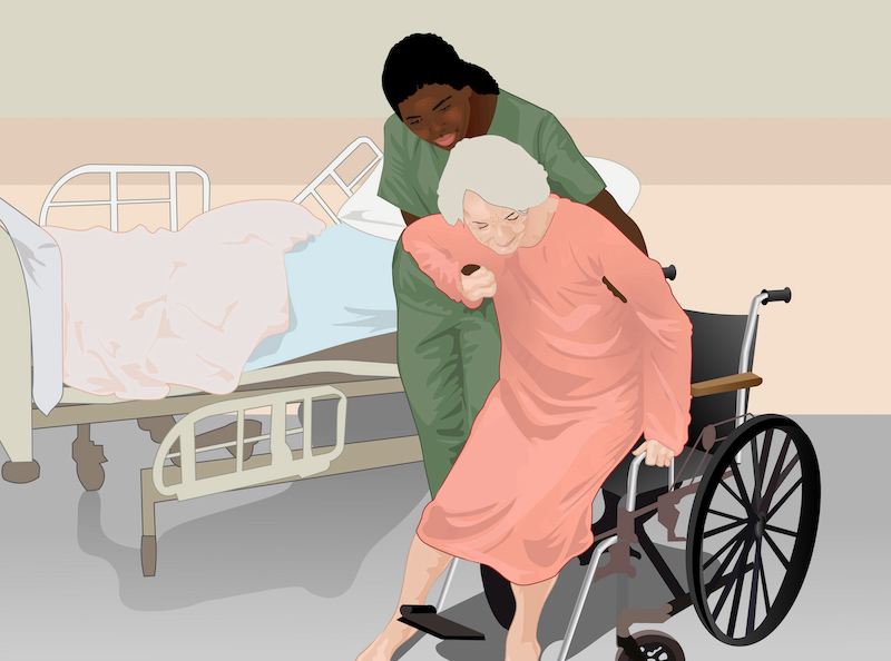 A nurse helping an elderly patient into a wheelchair